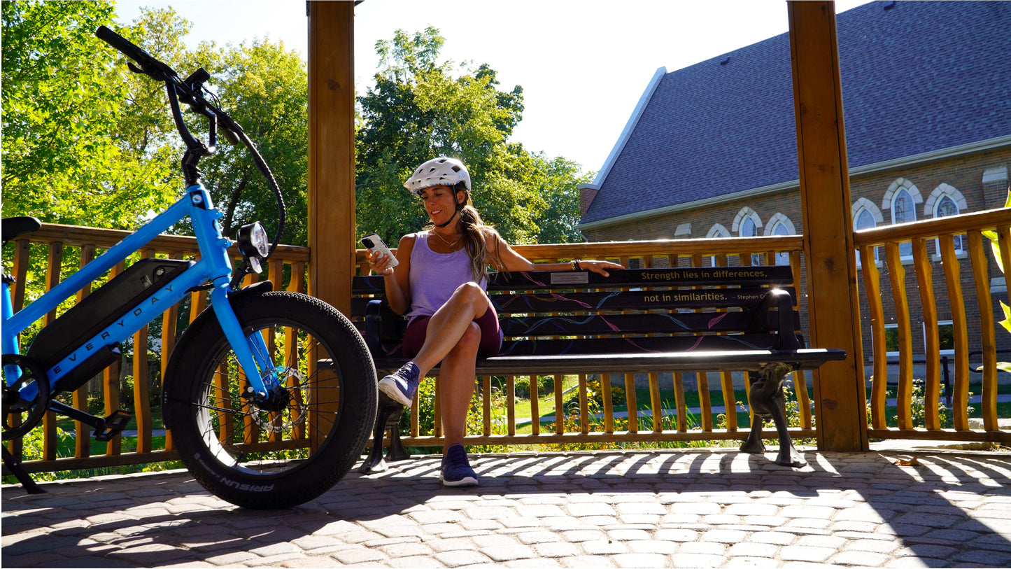 women resting beside an electric cargo bike